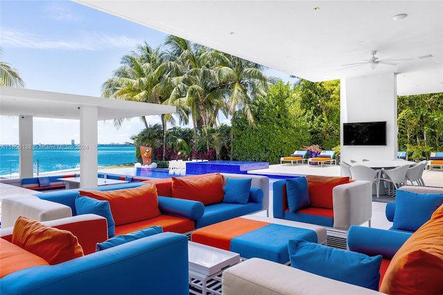 view of patio / terrace featuring ceiling fan, a water view, and an outdoor hangout area