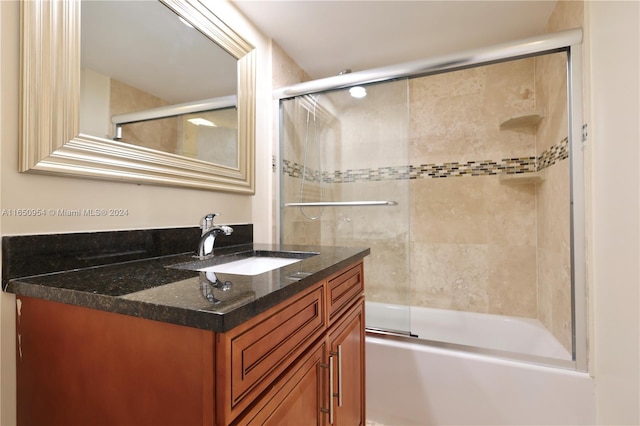 bathroom with combined bath / shower with glass door and vanity