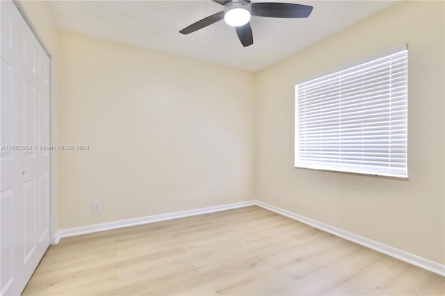 unfurnished room featuring baseboards, ceiling fan, and light wood finished floors