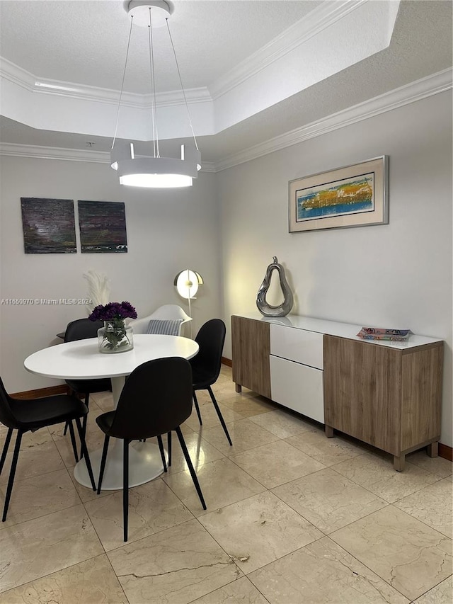 dining area with a raised ceiling, crown molding, and a textured ceiling