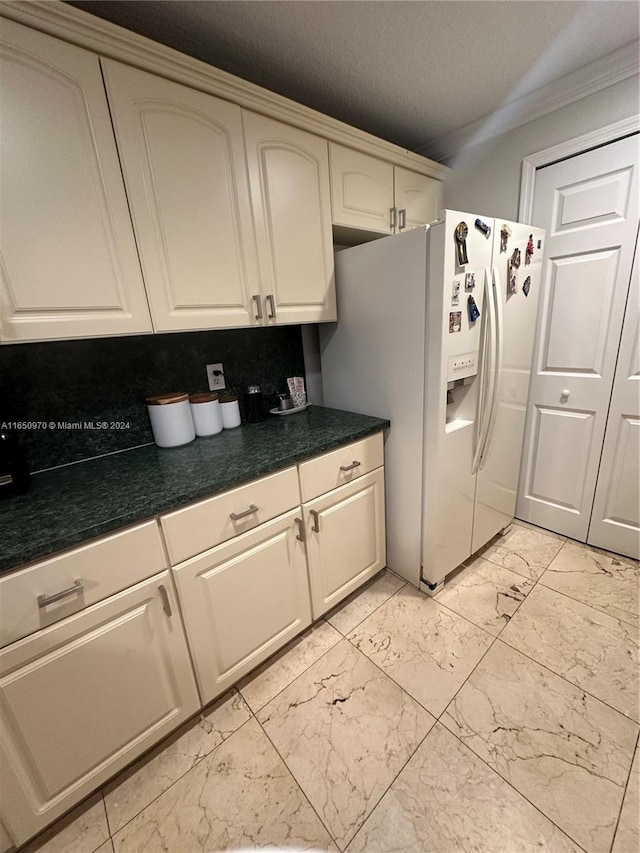 kitchen with backsplash, white fridge with ice dispenser, and crown molding