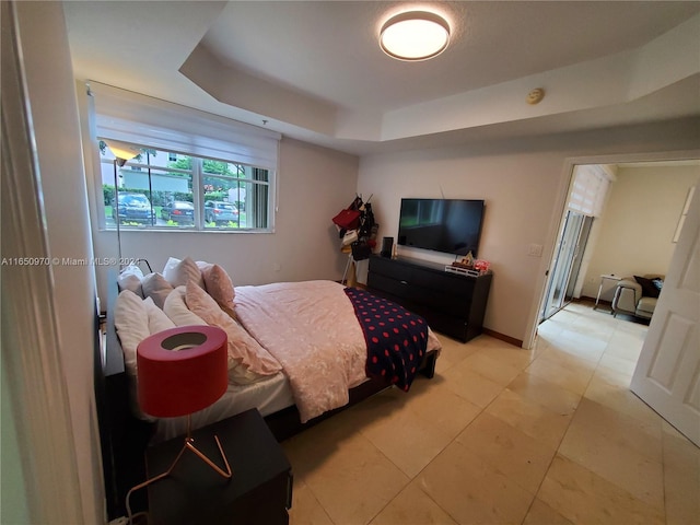 bedroom featuring a raised ceiling