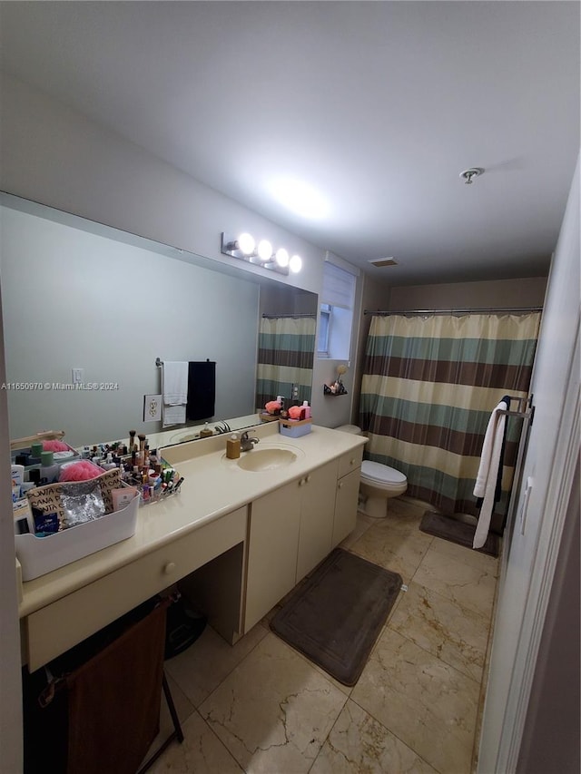 bathroom with vanity and toilet