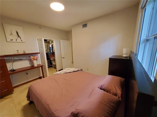 bedroom with a walk in closet and a closet