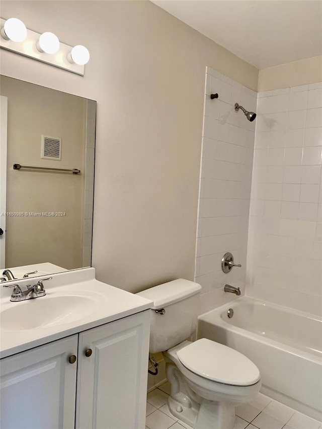 bathroom featuring tile patterned flooring, toilet, vanity, and bathtub / shower combination