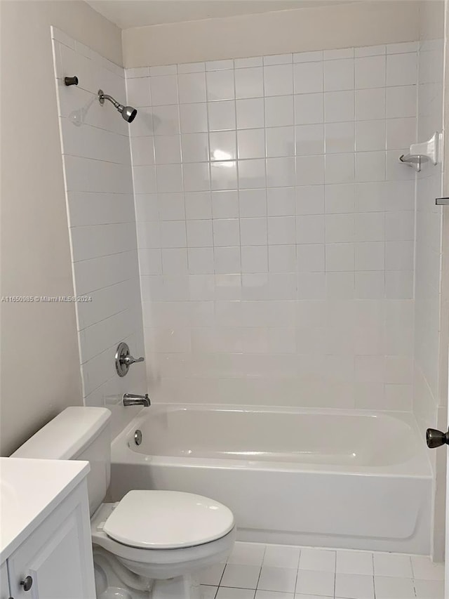 bathroom featuring vanity, tile patterned floors, toilet, and washtub / shower combination