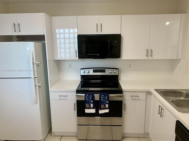 kitchen with light tile patterned floors, white cabinetry, black appliances, and light countertops