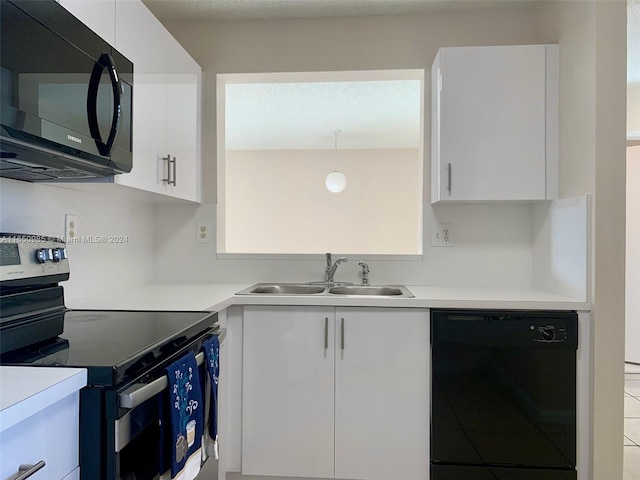 kitchen with modern cabinets, black appliances, a sink, white cabinets, and light countertops