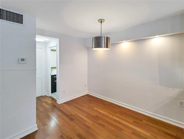 unfurnished dining area featuring dark wood-type flooring