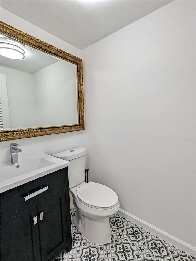 bathroom featuring tile patterned floors, vanity, and toilet