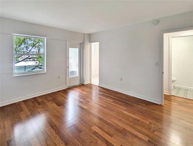 spare room with wood-type flooring