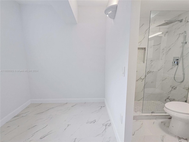 bathroom with tiled shower and toilet