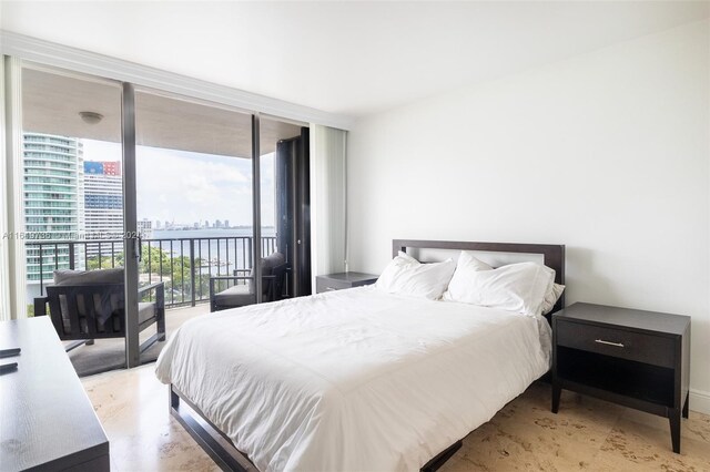 bedroom with a wall of windows and access to outside