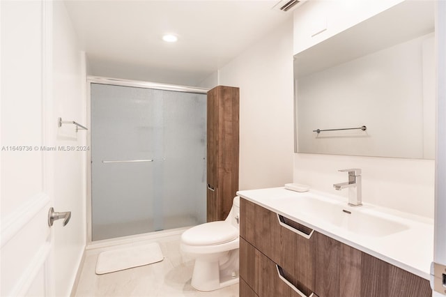 bathroom with vanity, toilet, walk in shower, and tile patterned flooring