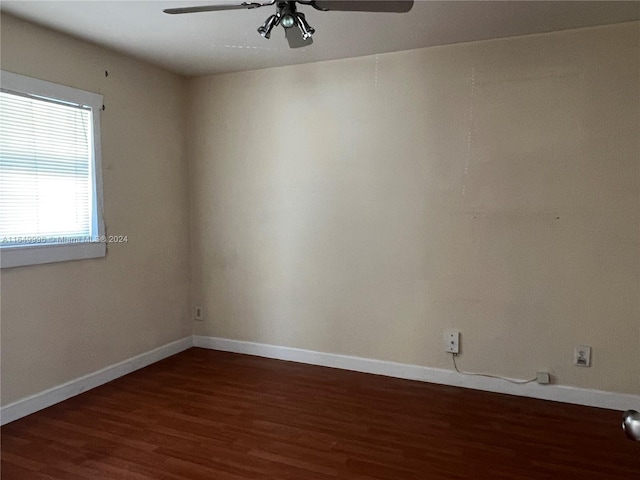 empty room with ceiling fan and dark hardwood / wood-style floors