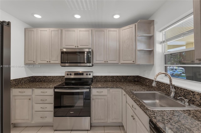 kitchen featuring light tile patterned floors, stainless steel appliances, and sink