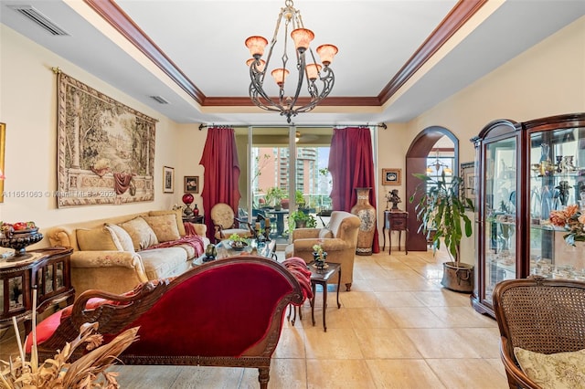 tiled living room featuring ornamental molding, a raised ceiling, and an inviting chandelier