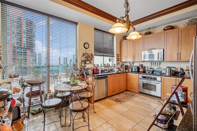 kitchen featuring pendant lighting, stainless steel appliances, sink, and ornamental molding