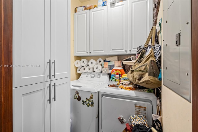 laundry room with washer and dryer and cabinets