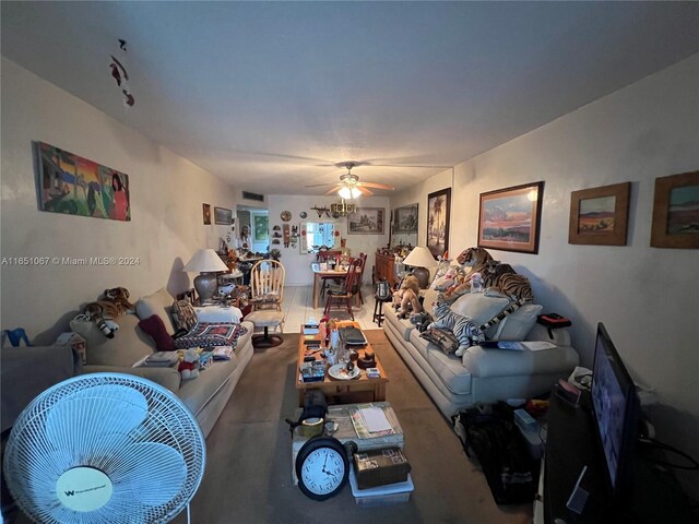 living room featuring ceiling fan and carpet floors