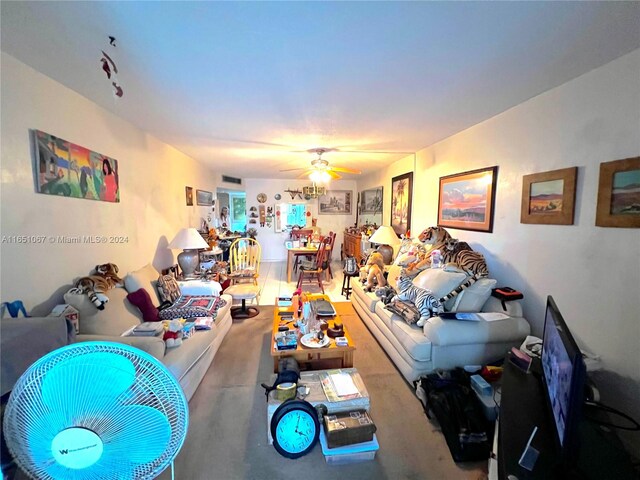 living room with ceiling fan and carpet flooring