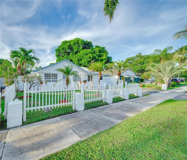 view of front of property with a fenced front yard and a front yard