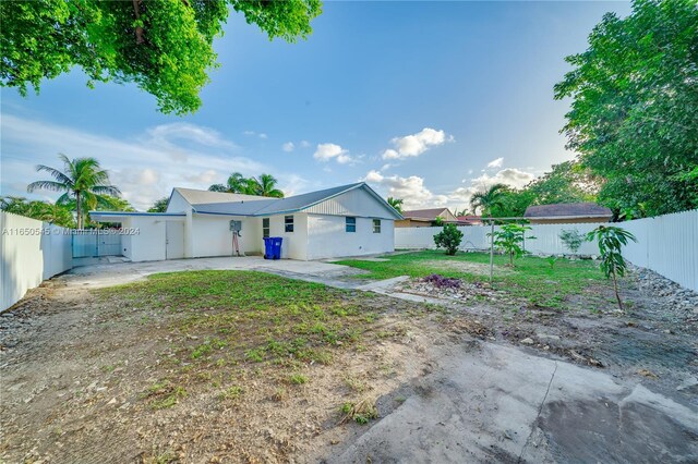 back of property featuring a fenced backyard and a patio