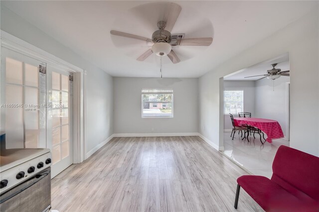 living room with ceiling fan and light hardwood / wood-style floors