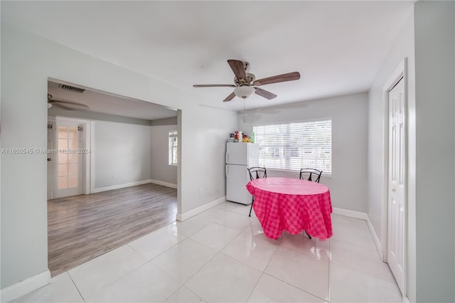 dining area with light hardwood / wood-style flooring and ceiling fan