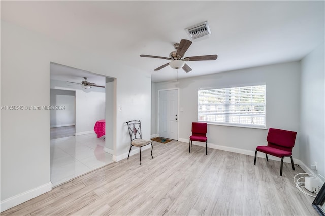 sitting room with light hardwood / wood-style flooring and ceiling fan