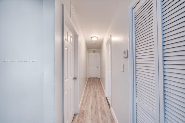 corridor with light hardwood / wood-style flooring