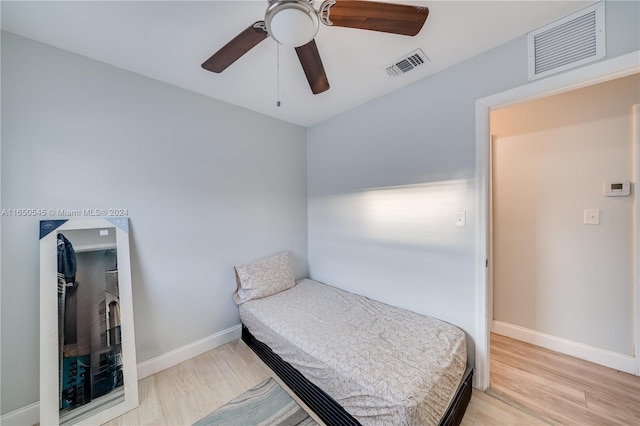 bedroom with light hardwood / wood-style flooring and ceiling fan