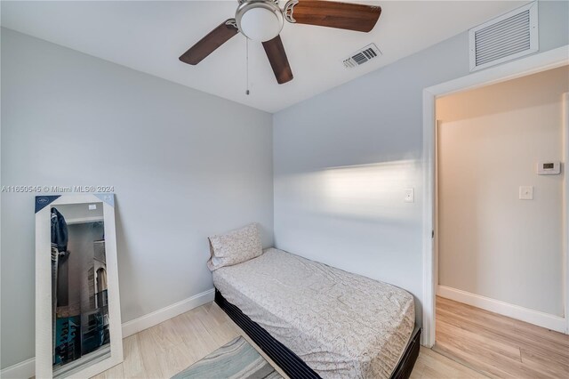 bedroom featuring light wood-type flooring, baseboards, and visible vents