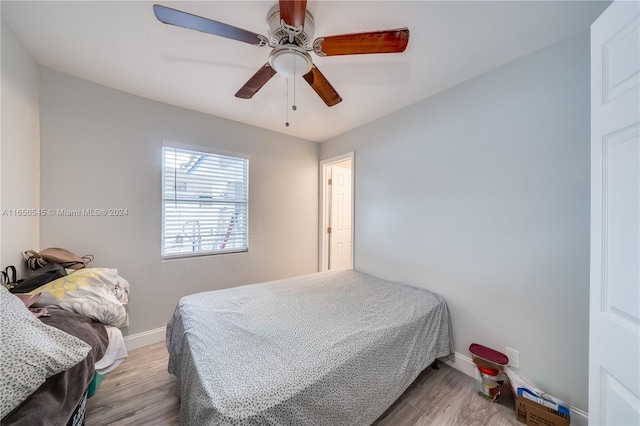 bedroom with ceiling fan and light wood-type flooring