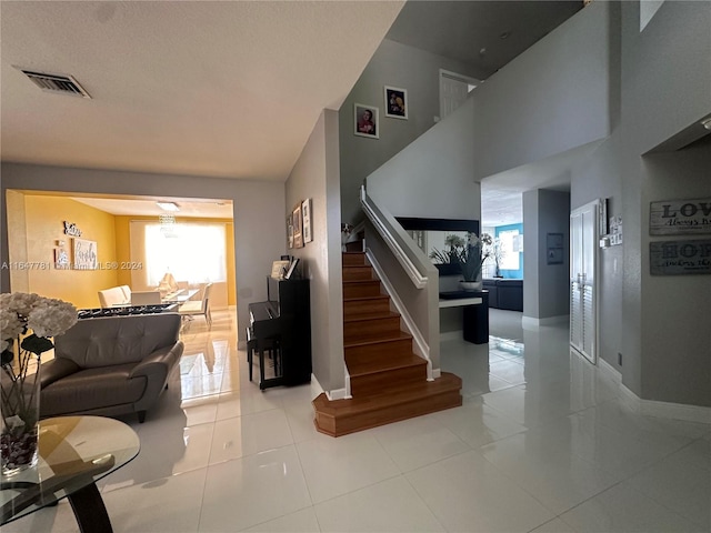 stairs featuring a healthy amount of sunlight and tile patterned floors