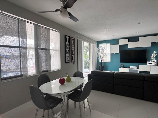 tiled dining room with ceiling fan