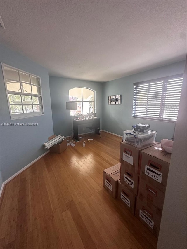 interior space with hardwood / wood-style floors and a textured ceiling