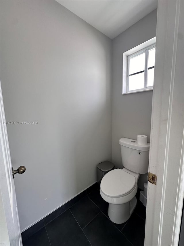 bathroom with tile patterned flooring and toilet