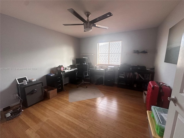 home office featuring hardwood / wood-style floors and ceiling fan