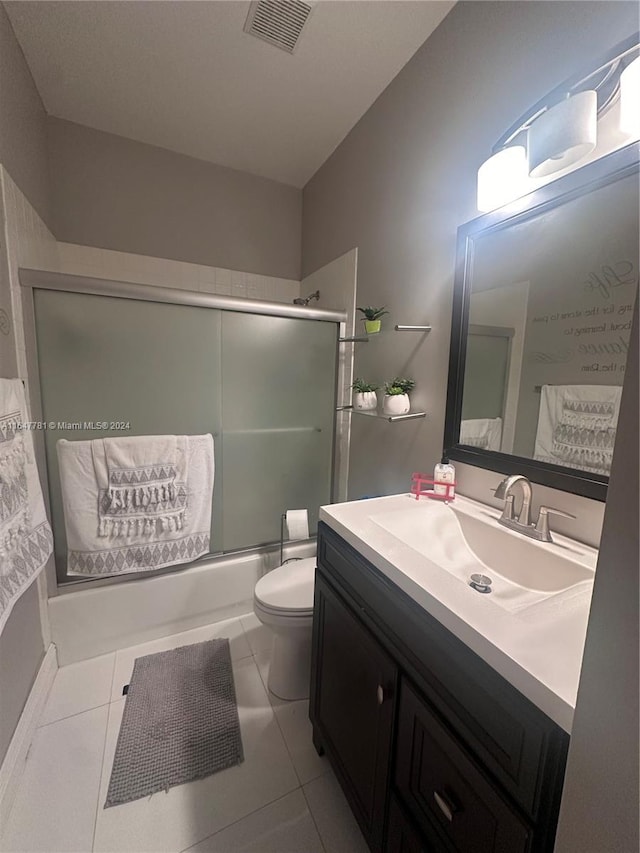 full bathroom featuring vanity, toilet, tile patterned floors, and enclosed tub / shower combo