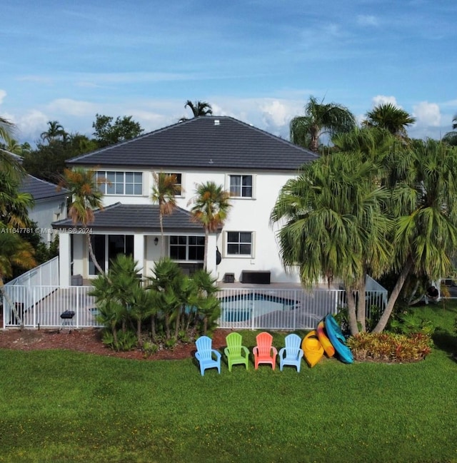 rear view of house with a yard