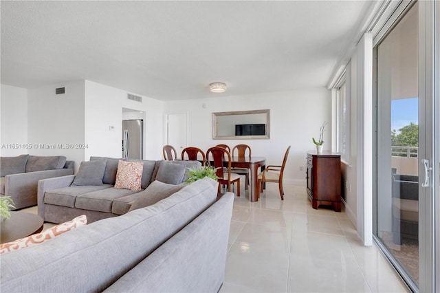 living room featuring light tile patterned floors and a textured ceiling