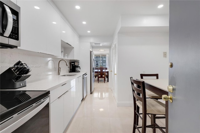 1080 94th St Unit 411, Bay Harbor Islands, FL 33154 - kitchen featuring stainless steel appliances, modern cabinets, white cabinets, light countertops, and recessed lighting