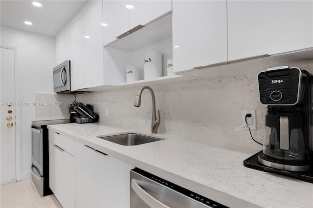 1080 94th St Unit 411, Bay Harbor Islands, FL 33154 - kitchen with appliances with stainless steel finishes, modern cabinets, white cabinets, and recessed lighting