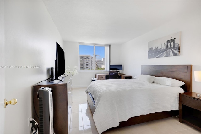 bedroom with light tile patterned floors