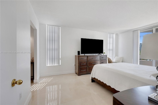 bedroom with light tile patterned floors