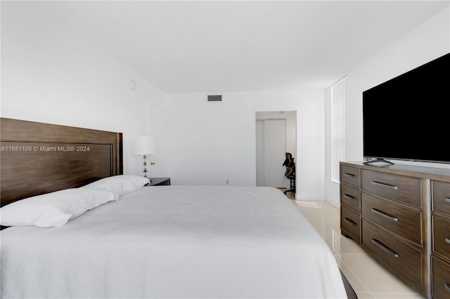 bedroom with light tile patterned floors