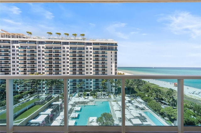 balcony featuring a beach view and a water view