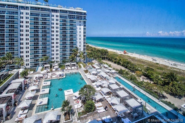 birds eye view of property featuring a view of the beach and a water view