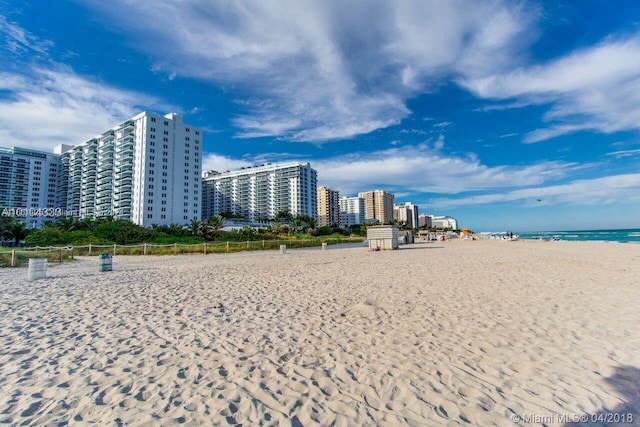 view of home's community with a water view and a view of the beach